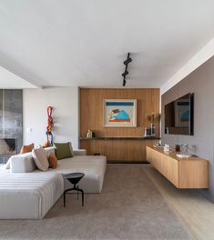 a living room filled with furniture and a flat screen tv on top of a wall