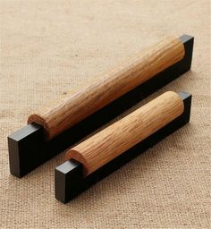 two black and wooden objects on a beige surface