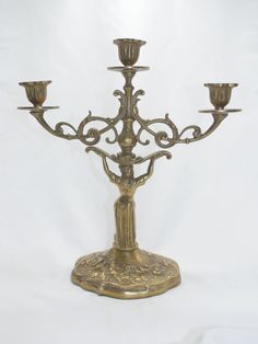 an ornate brass candelabra with five candles