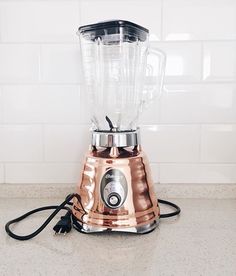 a blender sitting on top of a counter next to a white tile backsplash