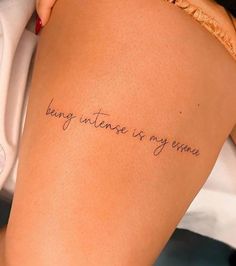 a woman's thigh with the words being intense is my escape written on it