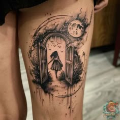 a woman's thigh with an open door tattoo on it