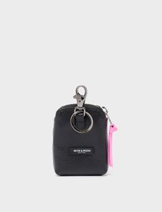 a small black purse with a pink tassell hanging from the front and side