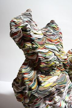 a sculpture made out of magazines sitting on top of a table