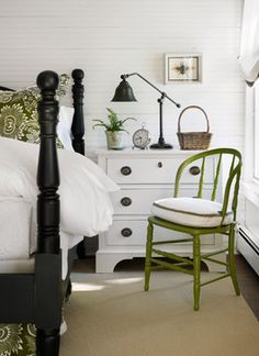 a bedroom with white walls and green accents