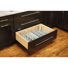 an open drawer in the middle of a kitchen