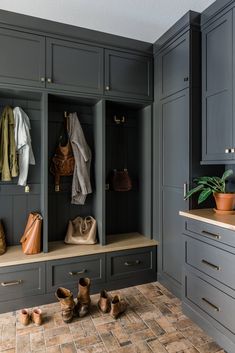 a kitchen with gray cabinets and wooden shoes on the counter top next to an oven