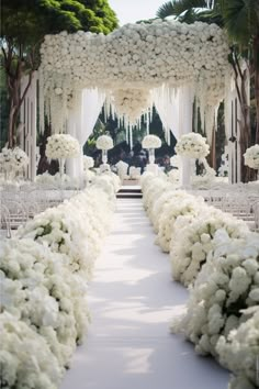 the aisle is lined with white flowers and greenery for an outdoor wedding ceremony in palm beach, florida