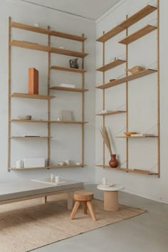 an image of a room with shelves on the wall and furniture in the corner, including a coffee table