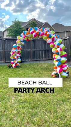 an arch made out of balloons in the yard with text overlay that reads beach ball party arch