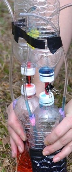 a woman holding two water bottles in her hands