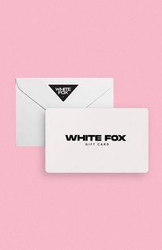 a white envelope with a black and white business card attached to it on a pink background