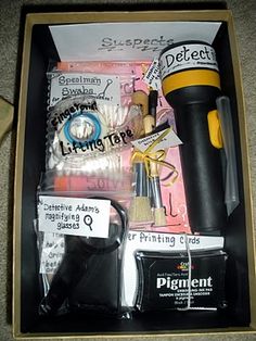 an open box containing various items such as glue, scissors, and other things in it