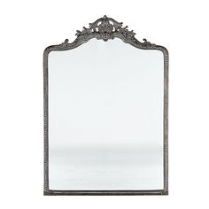 an ornate silver framed mirror against a white background