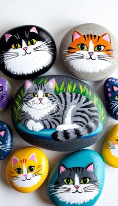 there are many painted rocks with cats on them