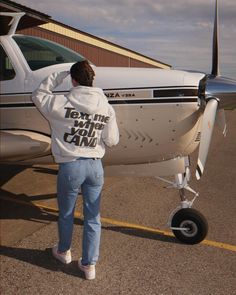 a person standing in front of an airplane