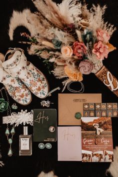 an assortment of items are laid out on a fur rug, including shoes and jewelry