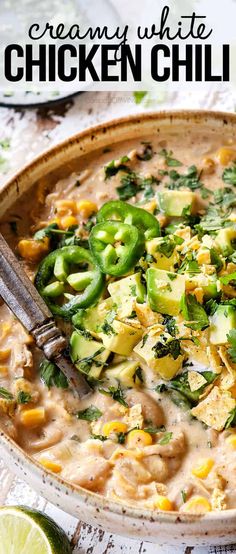 creamy white chicken chili in a bowl with limes and cilantro on the side