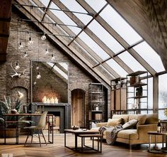 a living room filled with furniture under a skylight next to a fireplace and windows