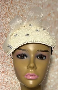 Cream/Beige Fascinator Half Hat, Church Head Covering, Tea Parties, Weddings.  Braided crinoline hat base accented with crinoline bows and rhinestones.  Hat measures 10 x 7 inches. Longer side goes from ear to ear. Gifts for mom, sister, wife, or yourself. Elegant Adjustable Bonnet For Church, Elegant Mini Hat With Curved Brim For Ceremony, Fitted Cream Hat For Ceremony, Cream Fitted Hat For Ceremony, Elegant Fascinator For Vintage Events, Adjustable Vintage Fascinator For Wedding, Elegant Short Brim Fascinator For Vintage Events, Gatsby Style Mini Hat Headband For Weddings, Elegant Headpiece For Kentucky Derby