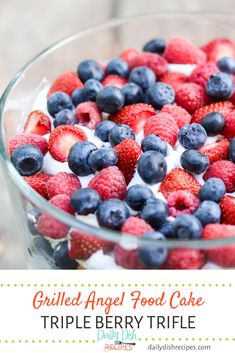 a glass bowl filled with berries and blueberries