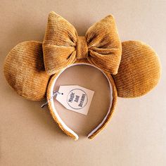 the ears and headbands are made out of brown material with a bow on top