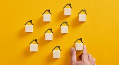 a hand points at several pieces of marshmallows on a yellow background