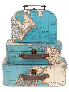 three suitcases stacked on top of each other in front of a world maps background