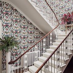 a stair case with decorative wallpaper on it