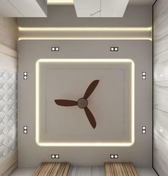 a ceiling fan in the middle of a room with white walls and wooden benches on either side