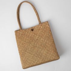 Handmade in Thailand by an artisan friend, this bag is perfect for the beach, the boat, the market, or the day. Size: 13”x5.5”. Made from all-natural jude. Please allow 6-8 weeks for delivery. Handwoven Natural Bucket Bag For Beach Season, Eco-friendly Palm Leaf Shoulder Bag For Vacation, Natural Handwoven Bucket Bag For Beach Season, Eco-friendly Beach Bag With Braided Handles, Eco-friendly Handwoven Shoulder Bag For Beach, Eco-friendly Handwoven Beach Shoulder Bag, Everyday Summer Handwoven Bucket Bag, Rectangular Natural Bag For Vacation, Natural Straw Tote Bag