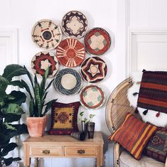 the wall is decorated with woven baskets and decorative pillows, along with potted plants