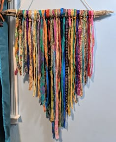 a multicolored piece of cloth hanging from a wall