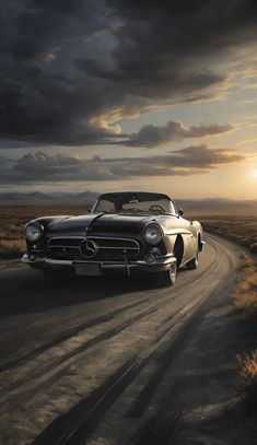 an old car driving down a dirt road in the desert at sunset with clouds overhead