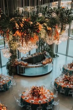 Focal bar at a luxury wedding with a vibrant floral chandelier in bold orange and teal, bringing an elegant and modern touch to the city skyline backdrop. Skyline Backdrop, Buffet Displays, Food Stations, Buffet Display, Food Displays