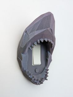 a light switch cover that is shaped like a shark's mouth