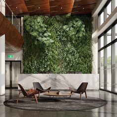 a living room with a large green wall in the center and two chairs on the floor