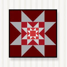 a red and grey quilted wall hanging on a white wall with pinstripe stripes