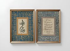 two framed pictures with calligraphy on them, one in blue and the other in gold