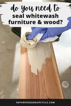 a person in blue gloves is painting wood with white paint on it and the words do you need to seal whitewash furniture & wood?