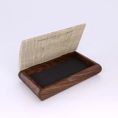 a wooden box with a black cloth inside