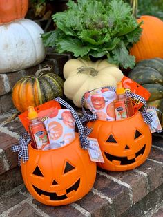 some pumpkins and gourds are sitting on the brick steps in front of plants