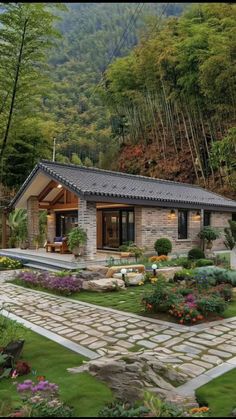 a stone house surrounded by lush green trees and flowers in the foreground is a path leading to it