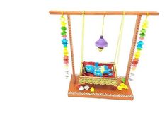 a wooden swing with beads hanging from it