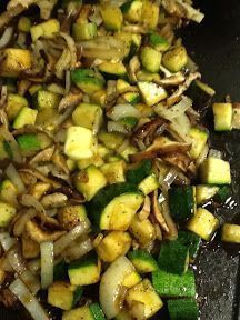 vegetables being cooked in a wok with oil on the stove top and seasoning