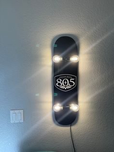 a skateboard is mounted to the wall with lights