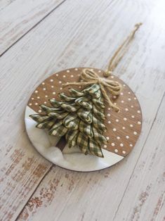 a wooden ornament with a christmas tree on it