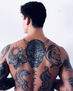 a man with many tattoos on his back