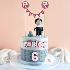 a birthday cake with an image of roblox on top