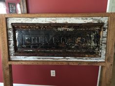 an old wooden sign with the word love written on it in black paint and wood frame